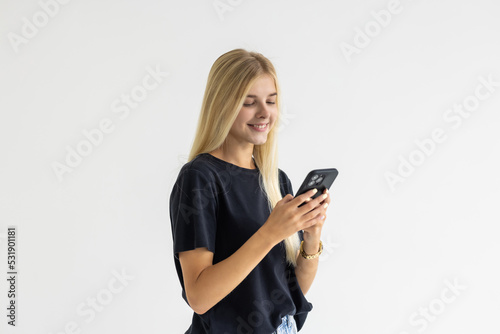 Portrait of a happy businesswoman using mobile phone isolated over white background
