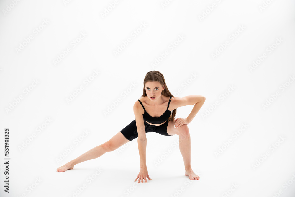 Beautiful brunette fitness woman doing yoga on a white background Beautiful brunette fitness woman doing yoga on a white background