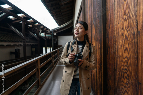 Canvas Print asian Japanese girl photographer appreciating wood structure of the building on corridor at Motorikyu Nijyojo nijo castle in Kyoto japan
