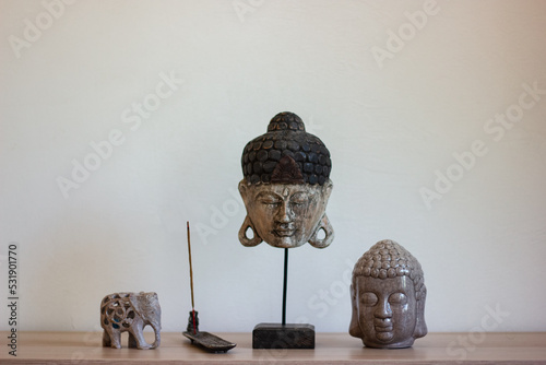Buddha heads, elephant and incense stick.
