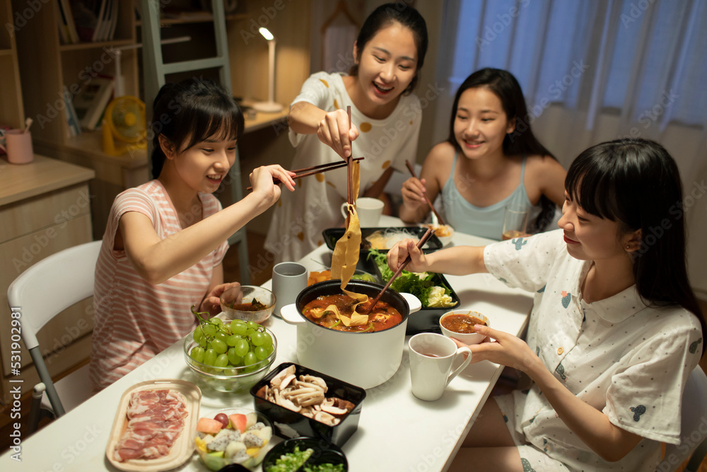 Young university students having chaffy dish in dormitory Young university students having chaffy dish in dormitory