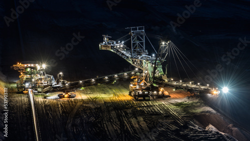 Illuminated excavator of an opencast mining scenery in Garzweiler.