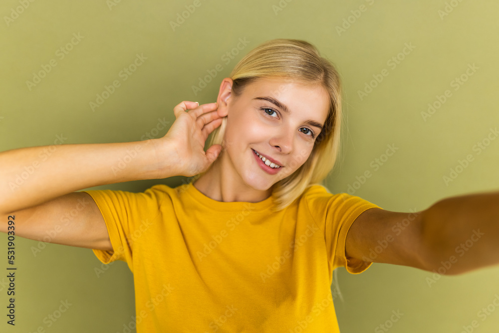 Self-portrait of attractive cheerful gorgeous wavy-haired girl day blog isolated over green color background Self-portrait of attractive cheerful gorgeous wavy-haired girl day blog isolated over green color background