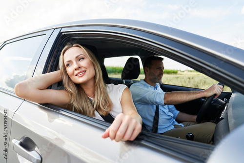 Blonde woman driving a car with husband © gpointstudio