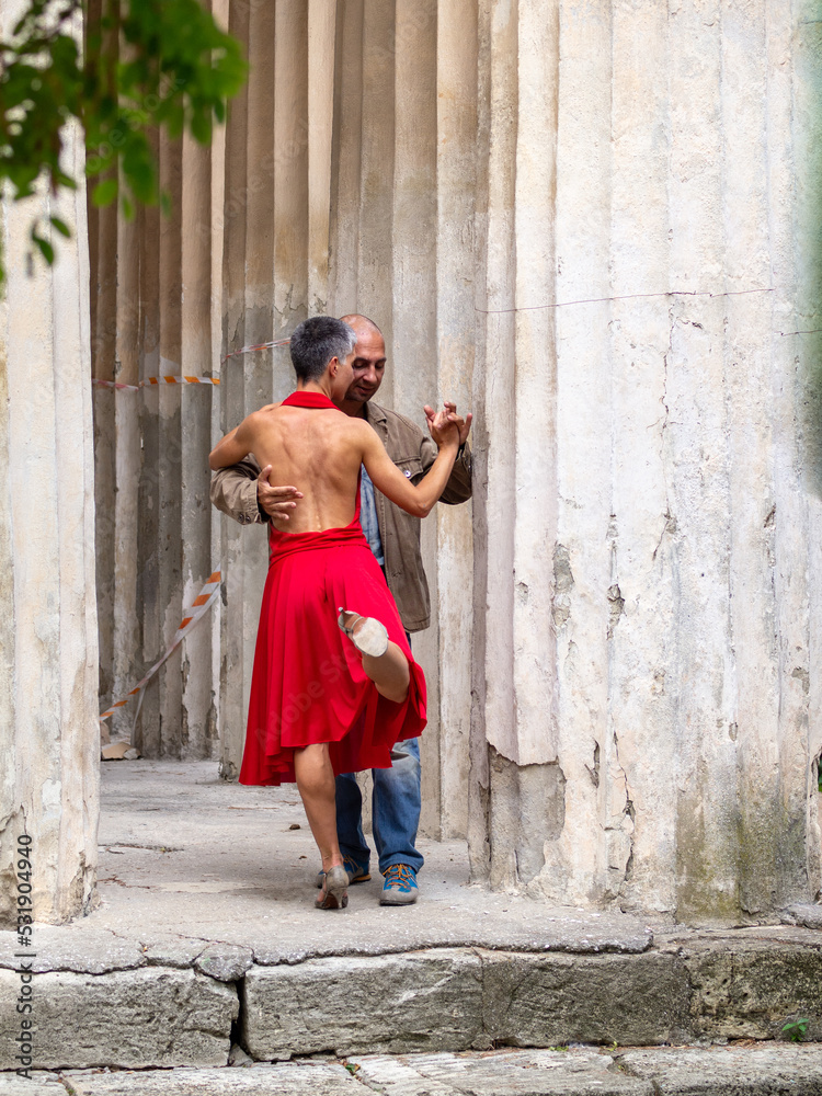 Tango nuevo dance - the famous partner dance with a woman in a red dress with the vibrant & playful style of movement, rich expressions, improvisation and close connection and passion between dancers
