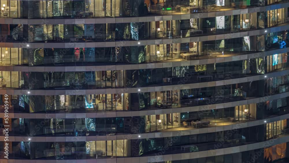 Outside view of windows in apartments of a high class building at night timelapse. Glowing lights in skyscraper from metal and glass Outside view of windows in apartments of a high class building at night timelapse. Glowing lights in skyscraper from metal and glass