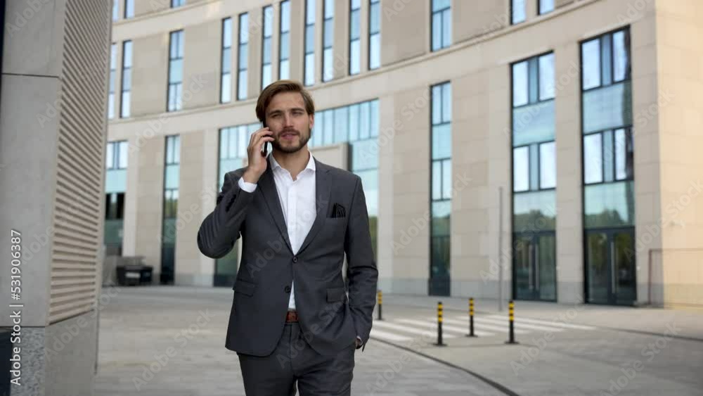 Handsome Startup Businessman using mobile Phone. Young man texting Messages, talking on his Smartphone while walking Handsome Startup Businessman using mobile Phone. Young man texting Messages, talking on his Smartphone while walking