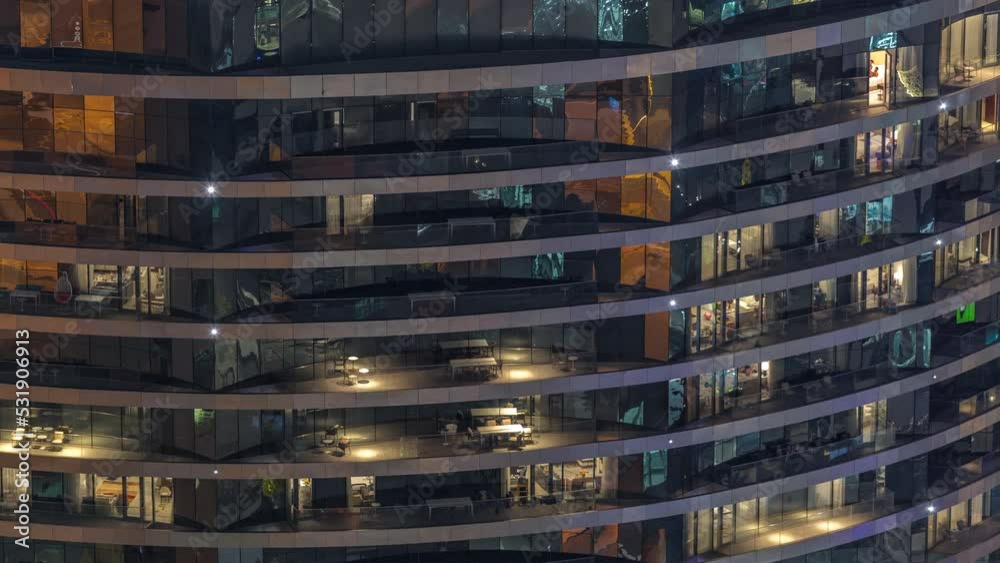 Outside view of windows in apartments of a high class building at night timelapse. Glowing lights in skyscraper. Chairs on balconies Outside view of windows in apartments of a high class building at night timelapse. Glowing lights in skyscraper. Chairs on balconies