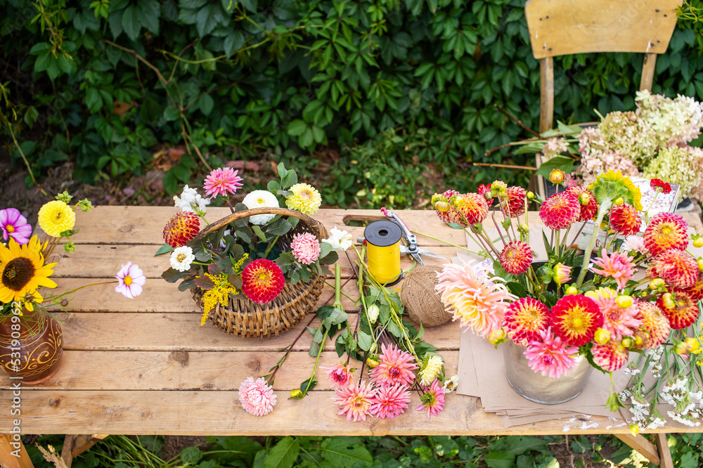 The florist's desk with autumn flowers and tools is on the street