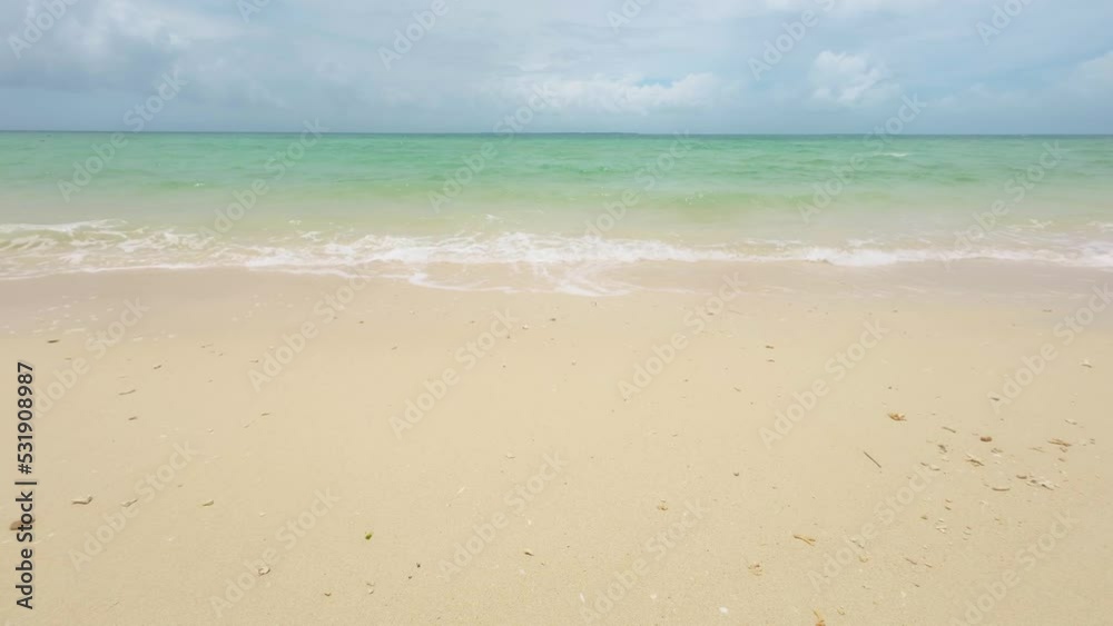 Waves crashing on a tropical sandy beach Waves crashing on a tropical sandy beach