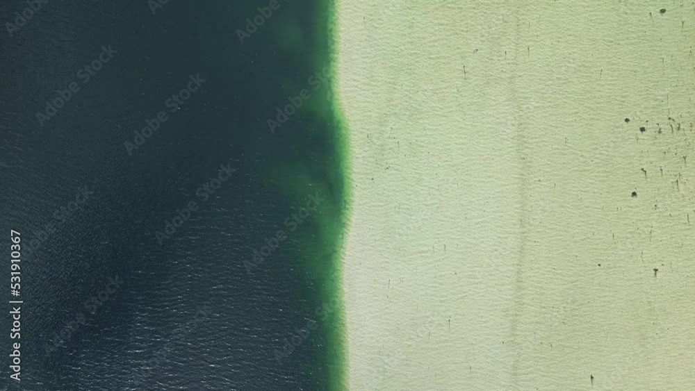Aerial view of Barrier between fresh and salt water on the Lofoten Islands in Norway with a sweeping movement upwards revealing the surrounding landscape of mountains and fjords. Aerial view of Barrier between fresh and salt water on the Lofoten Islands in Norway with a sweeping movement upwards revealing the surrounding landscape of mountains and fjords.