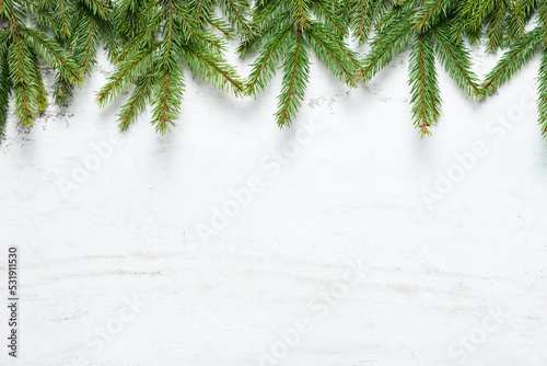 Natural fir tree branches in top of white textured background with space for text.  New Year and Christmas concept. Top view, copy space © Jurga Jot