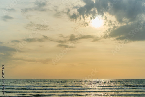 Sunset over the sea after a sandstorm, yellow tint from the sand in the air. Sea view, background with free space