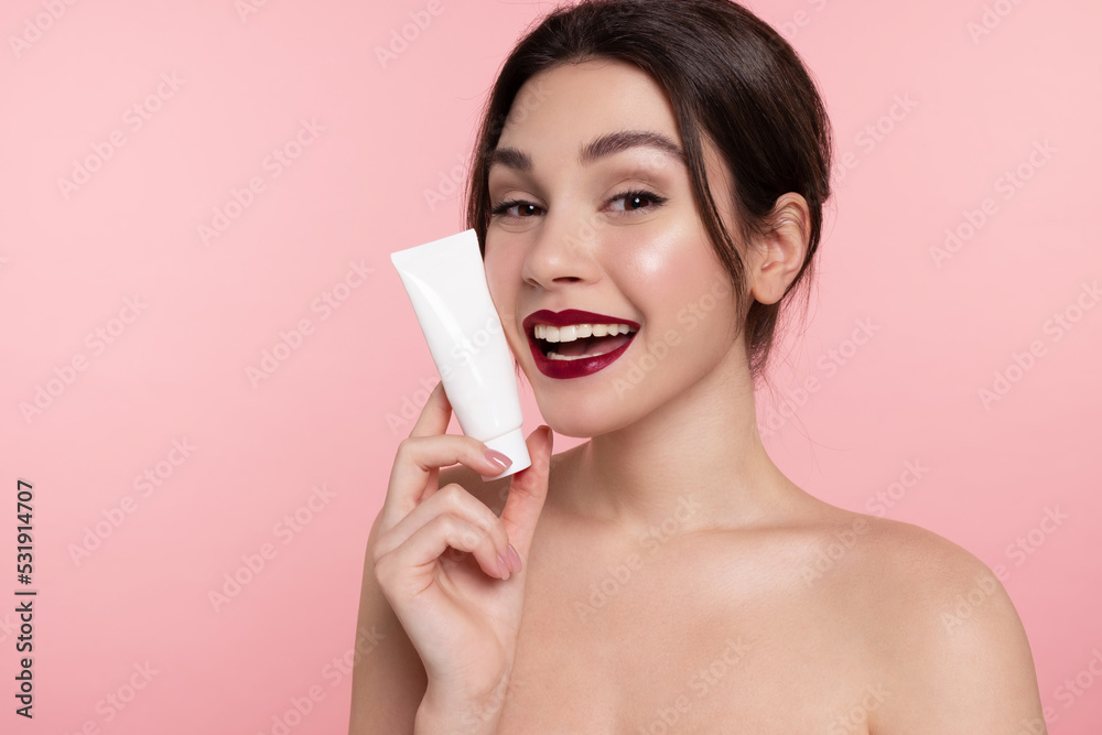 © deniskomarov - Beautiful  girl holding mock-up jar of cream. Woman with perfect glowing skin, bare shoulders showing makeup foundation template packaging tube on pink background. © deniskomarov - Beautiful  girl holding mock-up jar of cream. Woman with perfect glowing skin, bare shoulders showing makeup foundation template packaging tube on pink background.