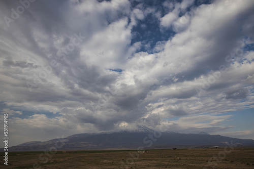 clouds in the sky and the snowy peaks of Mount Ararat