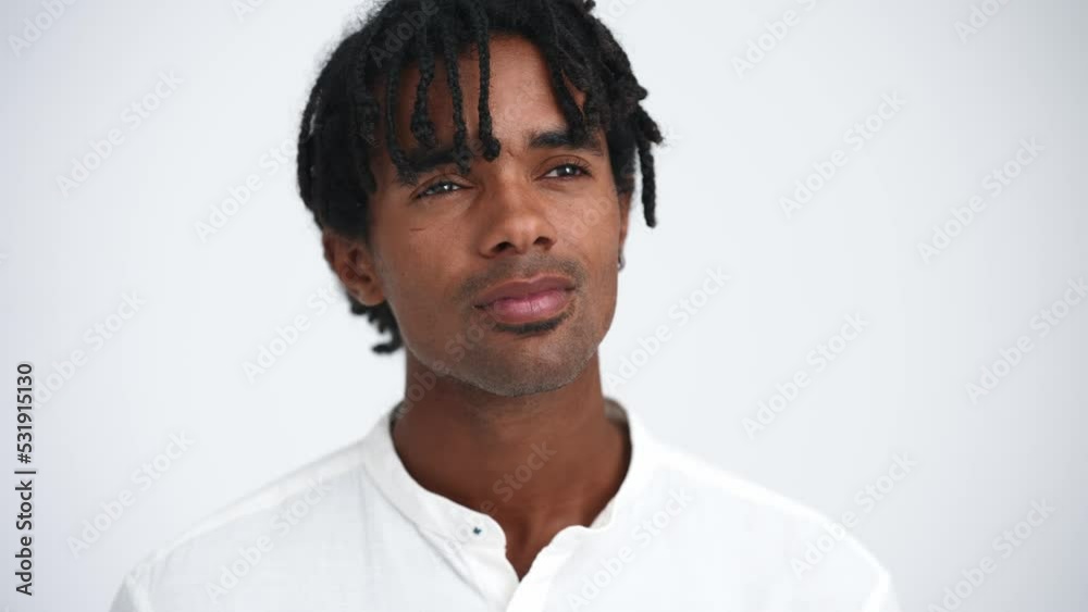 Face of pensive African man with dreadlocks thinking in the white studio Face of pensive African man with dreadlocks thinking in the white studio