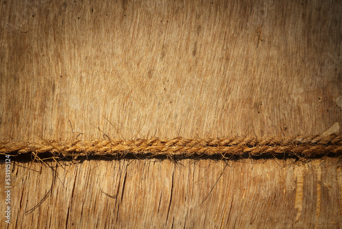 Old wooden background with a rope. Natural background - blank for design. Horizontal photo.
