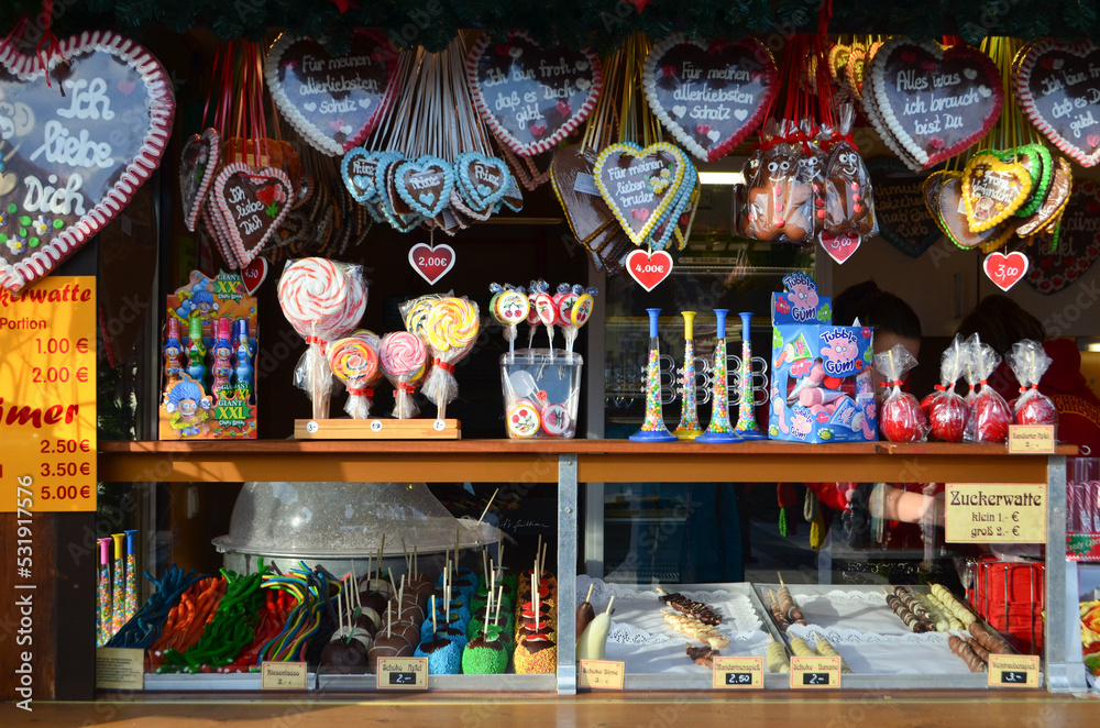 Gingerbread hearts, lollipops, fruits in chocolate and other sweets during the Christmas markets at the market place in Bautzen, Germany.