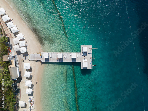 Fototapeta Naklejka Na Ścianę i Meble -  Turquoise Sea and White Umbrellas Drone Photo, Gocek Beach Fethiye, Mugla Turkey