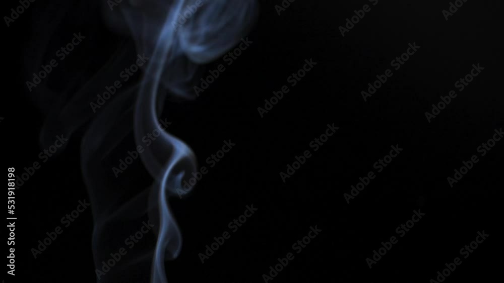 Abstract smoke rises up in beautiful swirls on black background. Abstract smoke rises up in beautiful swirls on black background.