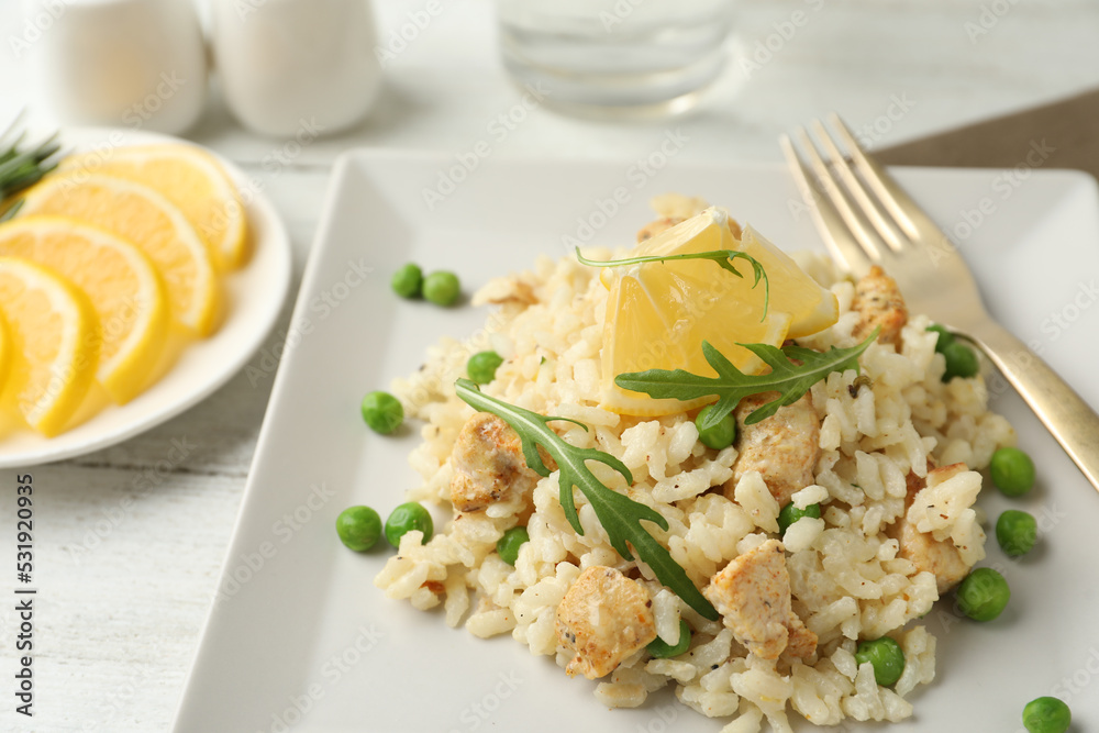 Delicious chicken risotto with lemon on table, closeup Delicious chicken risotto with lemon on table, closeup
