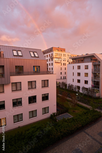 Concept of happy living in a modern house neighborhood and owning real estate. Contemporary resident complex in Europe during summer evenings.