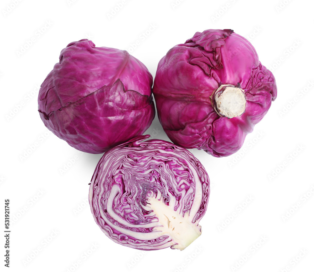 Fototapeta premium Whole and cut red cabbages on white background, top view