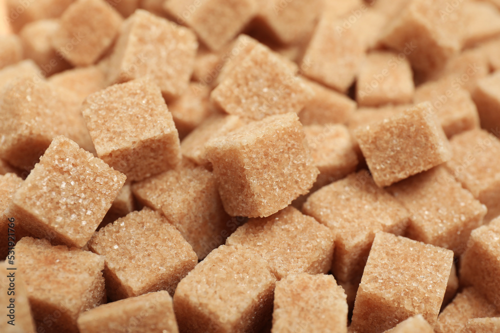 Brown sugar cubes as background, closeup view Brown sugar cubes as background, closeup view