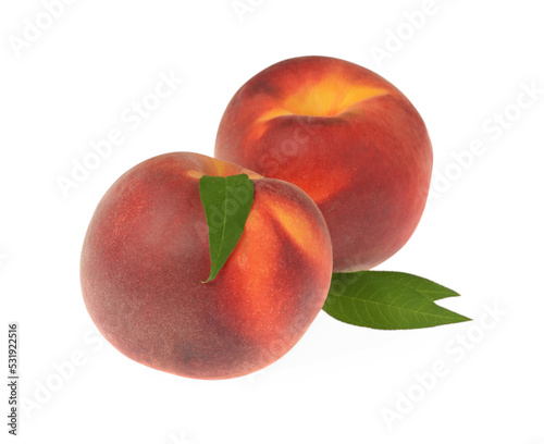Delicious fresh ripe peaches with green leaves isolated on white