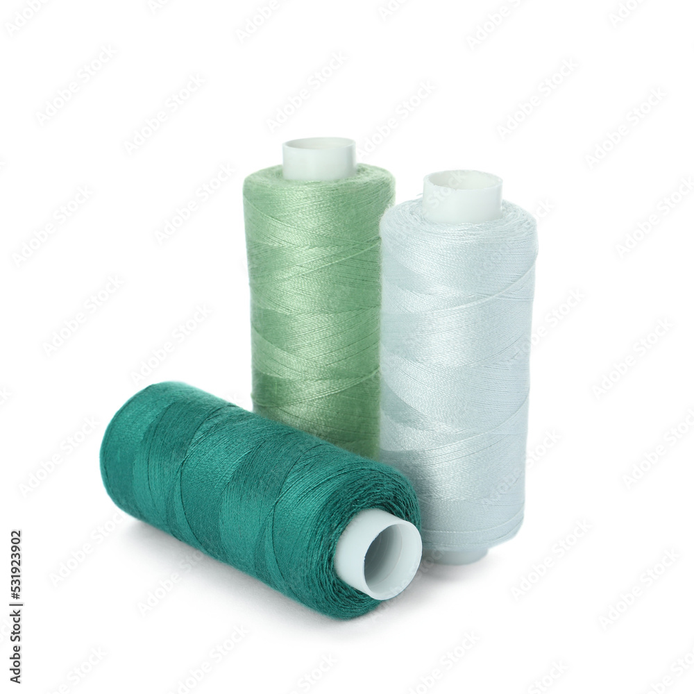 Different colorful sewing threads on white background Different colorful sewing threads on white background