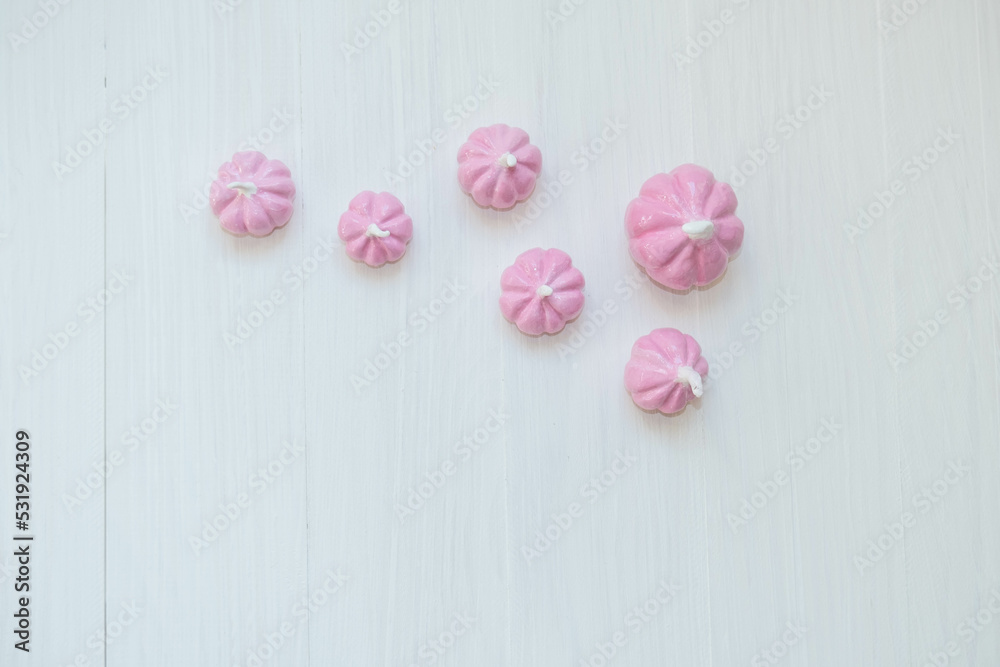 pale pink pumpkins on a light background , a place for text , an abstract Halloween concept pale pink pumpkins on a light background , a place for text , an abstract Halloween concept