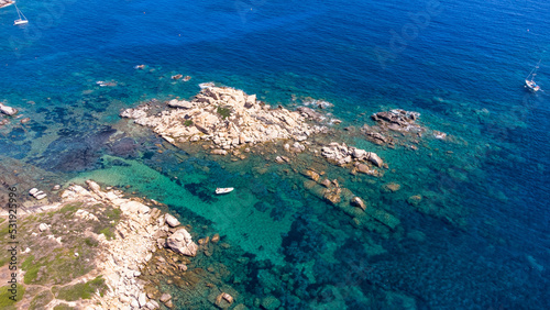 An amazing aerial view of the Sardinian coast. The wonderful colors of the sea contrast with the colors of the rocks.