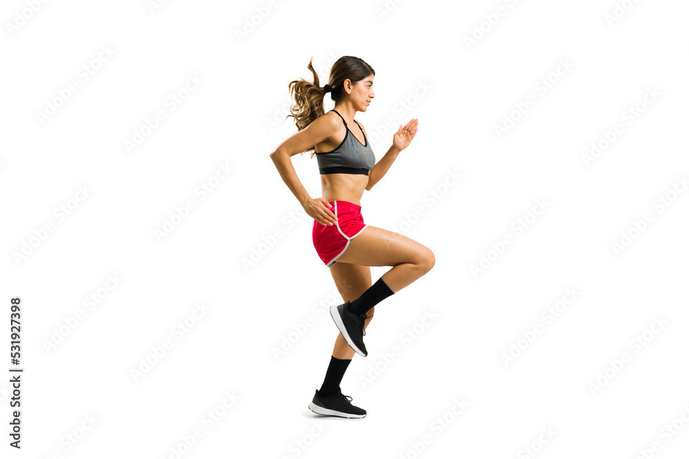 Sporty young woman running in place in full length Sporty young woman running in place in full length