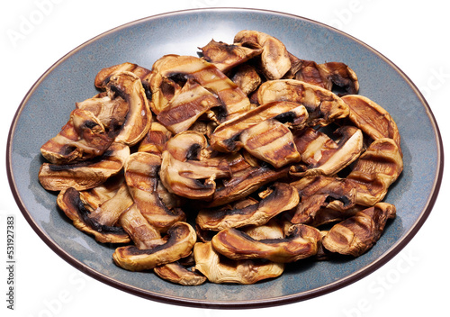 Grilled Slices of champignon mushrooms with stripes from a grill in ceramic plate