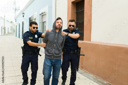 Cops bringing a criminal suspect to the police station