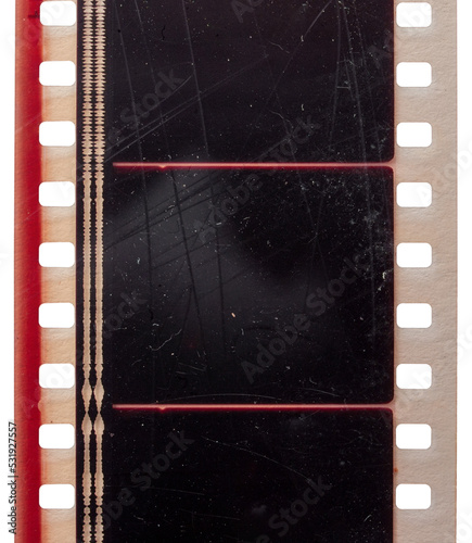 macro photo of empty or blank 35mm cinefilm strip with scratches photo