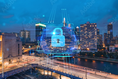 Aerial panoramic cityscape of Philadelphia financial downtown at night time, Pennsylvania, USA. Glowing Padlock hologram. The concept of cyber security to protect companies confidential information © VideoFlow