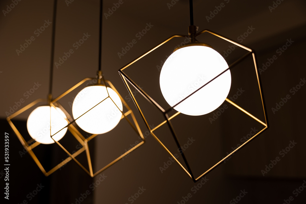A set of lamps. Soft evening light indoors. Chandelier in modern style. Yellow light.
