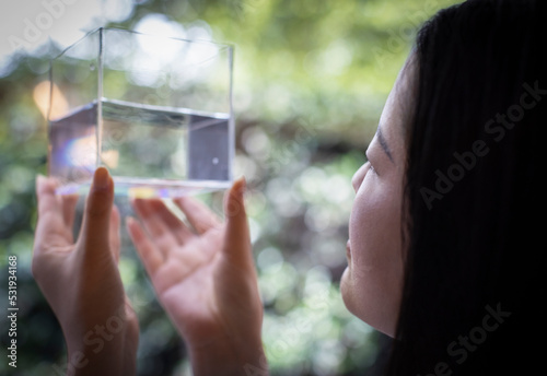 Close up woman holding cube with water photo