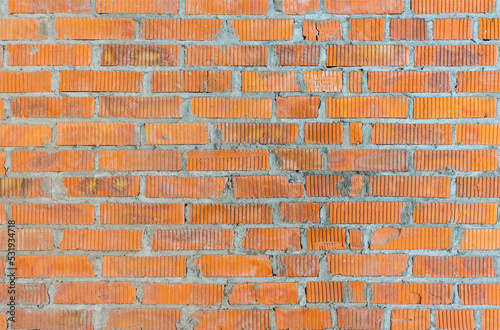 Wall in a new building made of red brick, construction texture