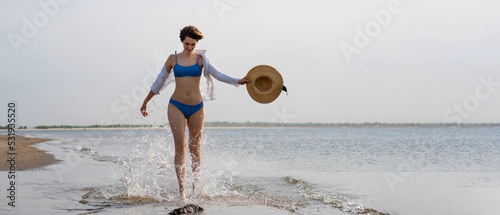 Girl in bikini walks on beach
