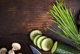 Fresh vegetable and knife on a rustic wood board. Healthy cooking composition, food frame, background with copy space.