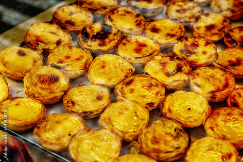 Closeup of fresh pastel de nata, traditional portugal dessert, delicious baked creamy pastry on the counter photo