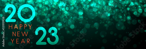 Banner with 2023 happy new year sign on green bokeh background.