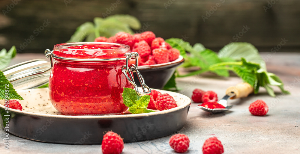 Homemade raspberry jam in jar with raspberries and mint. Long banner format. place for text Homemade raspberry jam in jar with raspberries and mint. Long banner format. place for text