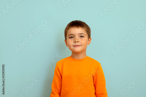 portrait of a child on a light blue background copy space. portrait of a little boy 5 years old