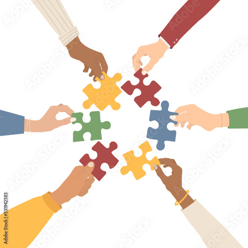 Teamwork. Multi-ethnic group holding puzzles. The concept of cooperation and partnership. Flat style. Vector illustration