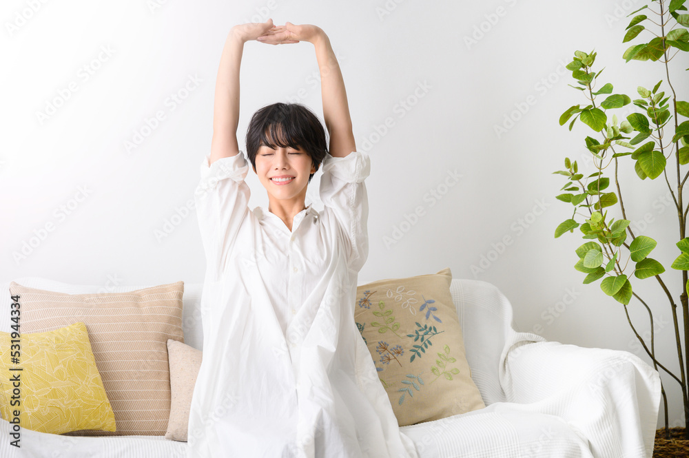 Woman stretching comfortably in her room