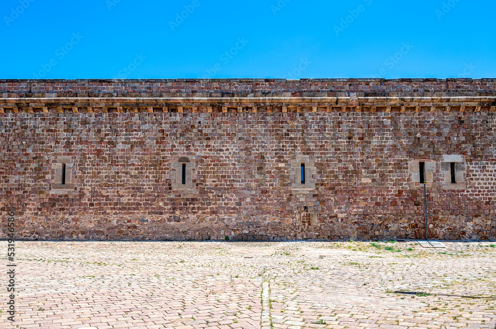 Montjuic Castle. Medieval stone wall architecture inside of the