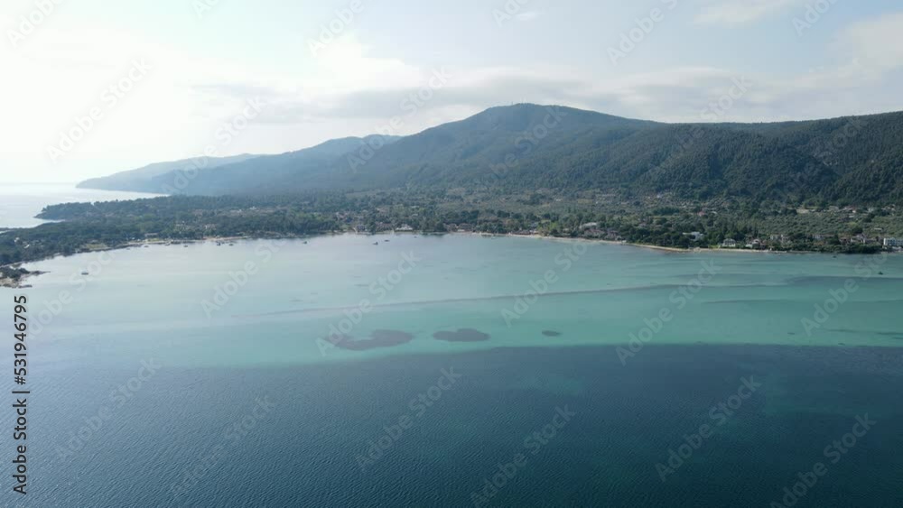 Aerial view of Vourvourou in Greece, famous summer travel destination in Europe, small village in the coast with clean and calm turquoise sea water Aerial view of Vourvourou in Greece, famous summer travel destination in Europe, small village in the coast with clean and calm turquoise sea water